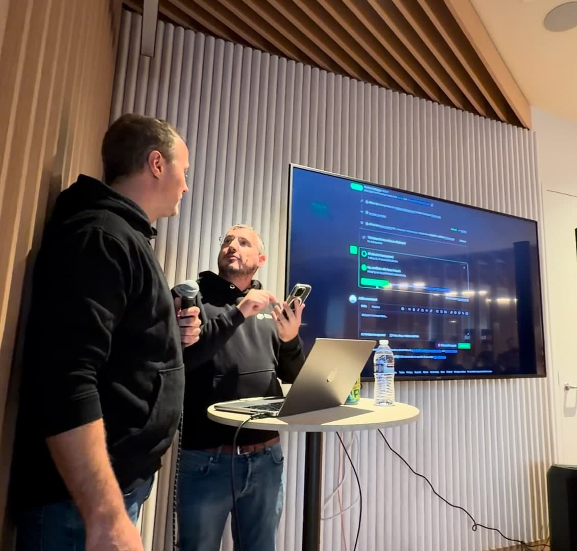 Merging Effect 4.0 live on stage at CodeRabbit, the release pull request on the screen behind the two speakers